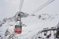 Red Brevent cable car cabin suspended in the air, Chamonix Mont Blanc.