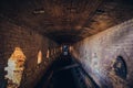 Red brick abandoned underground sewer tunnel with dramatic mysterious atmosphere, inside sewerage Royalty Free Stock Photo