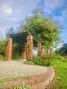 A red brick arch full of climbing plants. Vertical photo image.