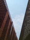 Red brick architectural building on bright blue sky background