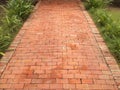 Red brick block stone footpath with grass in the garden