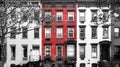 Red brick building isolated against row of old black and white buildings in Manhattan New York City Royalty Free Stock Photo