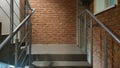 Red brick building with a modern staircase in a loft style with metal railing. Stairs adorn the building. Modern stairwell. Steel Royalty Free Stock Photo