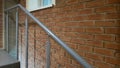 Red brick building with a modern staircase in a loft style with metal railing. Stairs adorn the building. Modern stairwell. Steel Royalty Free Stock Photo