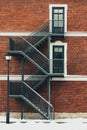 Red brick building. Staircase, the facade of the building. fire exit. Royalty Free Stock Photo