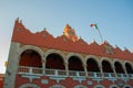 Red brick building tower with golden dome and clock in the City center of Merida. Mexican flag flutters on air. City Town hall of Royalty Free Stock Photo