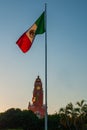 Red brick building tower with golden dome and clock in the City center of Merida. Mexican flag flutters on air. City Town hall of Royalty Free Stock Photo