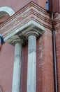 Red brick building with two gray columns. Concrete columns. Drai