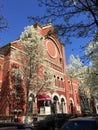 Red brick church white flowering trees