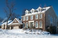 Red Brick Colonial Home in the Winter Snow Royalty Free Stock Photo