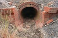 Red brick culvert drain under road Royalty Free Stock Photo
