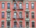 Red brick facade, and fire stairs. Harlem, NYC