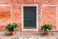 Red brick facade of the house with wooden door in Venice, Italy Royalty Free Stock Photo