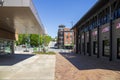 A red brick footpath at the Tennessee Aquarium with red brick buildings and lush green trees and gorgeous clear blue sky