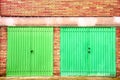 Red brick garage green door