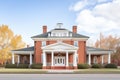 red brick georgian mansion with a hip roof and white columns