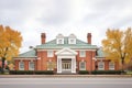 red brick georgian mansion with a hip roof and white columns Royalty Free Stock Photo