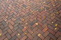 Red brick herringbone pattern background with yellow leaves