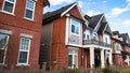 Red brick homes side by side. Row of Typical English Terraced Houses, townhomes.