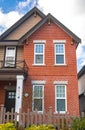 Red brick homes side by side. Row of Typical English Terraced Houses, townhomes.