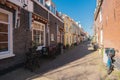 A red brick house wall, with a bench and a bicycle in front of it, in Delft, Netherlands Royalty Free Stock Photo