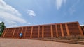 Red brick architectural building on bright blue sky background