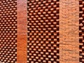 Red brick architectural building on bright blue sky background