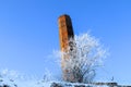 Red brick industrial chimney on a blue sky background Royalty Free Stock Photo