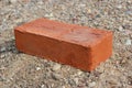 Red brick lying on the sand Royalty Free Stock Photo