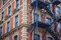 Red brick office or apartment building with metal fire escape. Royalty Free Stock Photo