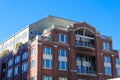 A red brick office building with recessed balconies with clear blue sky at Atlantic Station in downtown Atlanta Royalty Free Stock Photo