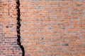 Red brick wall with huge black crack Royalty Free Stock Photo