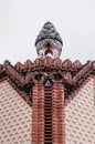 Red brick ornate vintage wall of Pavilion Guell in Barcelona, Spain