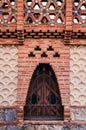 Red brick ornate vintage wall of Pavilion Guell in Barcelona, Spain