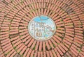 A Circular Of Old Red Brick Floor Pattern Background Texture With Mosaic Picture In The Middle