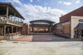 A red brick performing stage in the center of O`neal Plaza with red brick buildings and a gorgeous blue sky with clouds