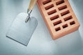 Red brick plastering trowel on concrete surface bricklaying conc