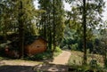 Red brick ruin of 1960s in woods by path