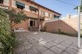 Red brick single family home patio with entry stairs,