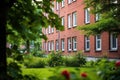 red brick single-room occupancy building with green surroundings