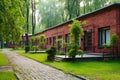 red brick single-room occupancy building with green surroundings