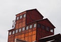 Red brick stone building with iron parts and windows in the city during the daytime Royalty Free Stock Photo