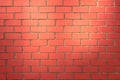 Red brick wall illuminated by the sun