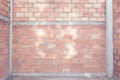 Red brick wall background under house construction,vintage filter effect Royalty Free Stock Photo