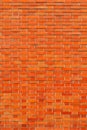 Red brick wall background. Vertical shot of brickwork pattern as textured graphic design element