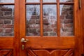 Red brick wall behind glass door or window. Royalty Free Stock Photo
