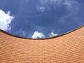 Curved brick wall and blue sky