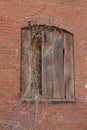 Red brick wall with boarded window Royalty Free Stock Photo