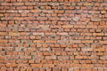 Red brick wall with cement. Rough surface texture. Texture of an old brick wall. Royalty Free Stock Photo