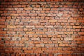 Wall of red brick with cement with vignette. Rough surface texture. Texture of an old brick wall Royalty Free Stock Photo